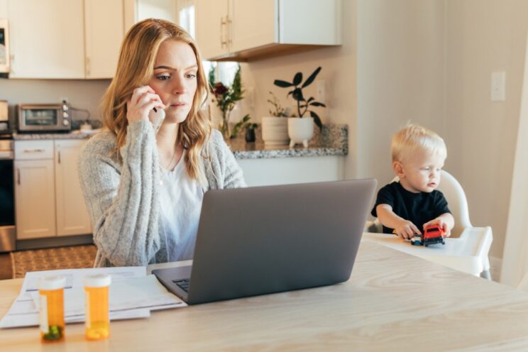 a concerned mother making a phone call while she reviews her pharmacy bills